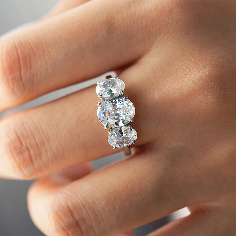 Anel três pedras ovais de moissanite usado na mão