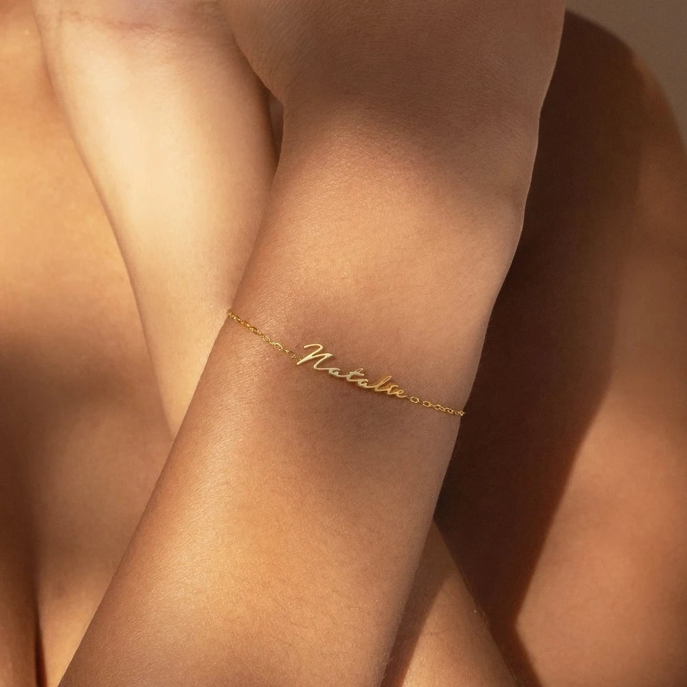 Pulseira com nome Natalia dourada no pulso